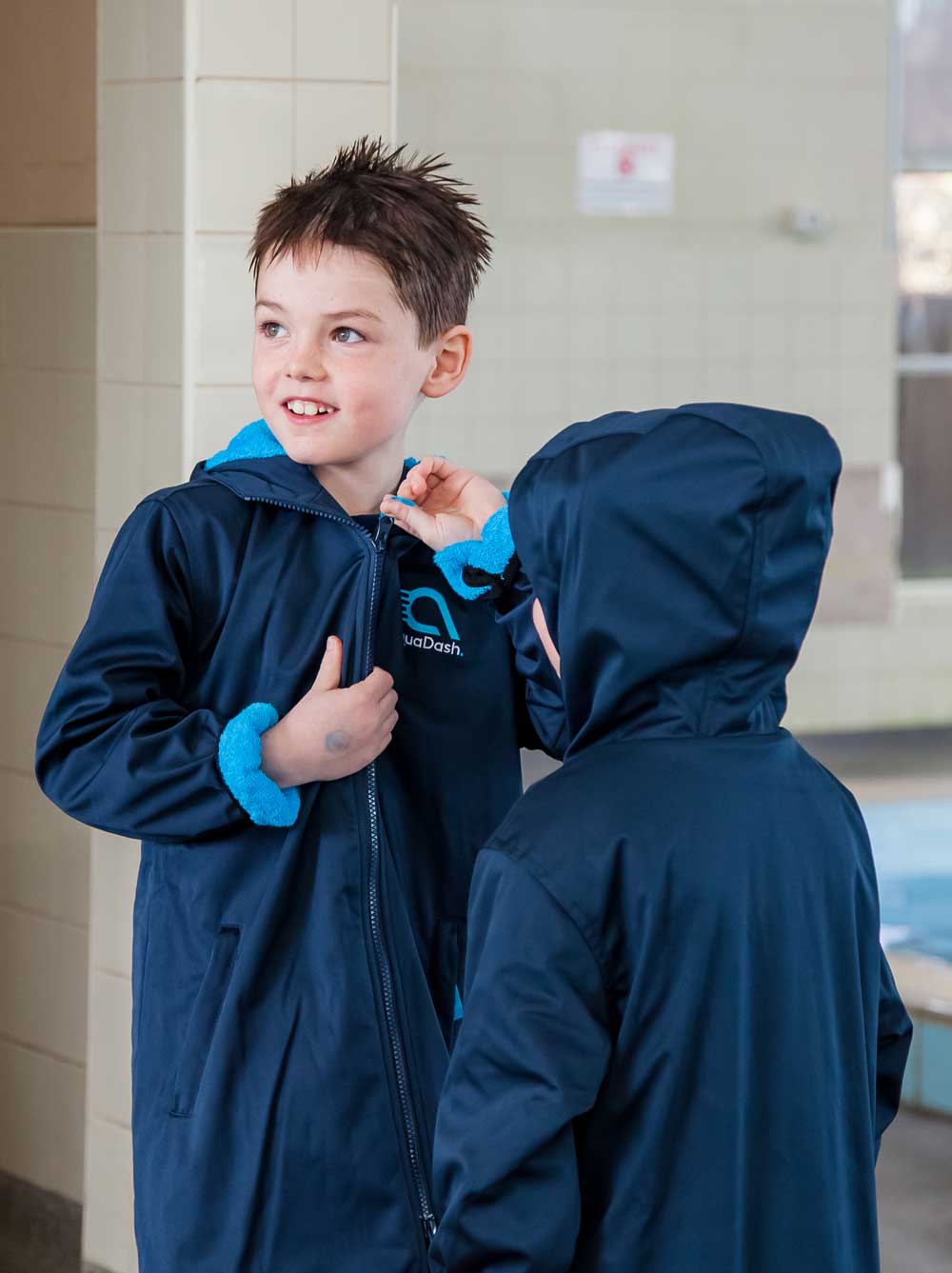 Boy wearing swim parka after swimming